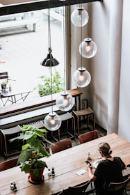 woman in black shirt sitting by the table