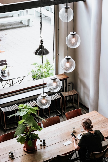 woman in black shirt sitting by the table