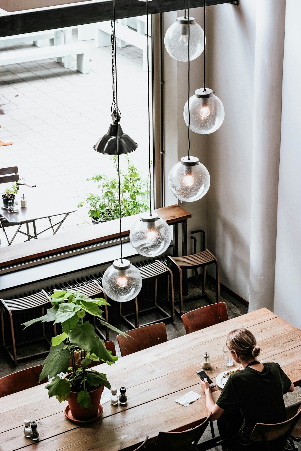 woman in black shirt sitting by the table