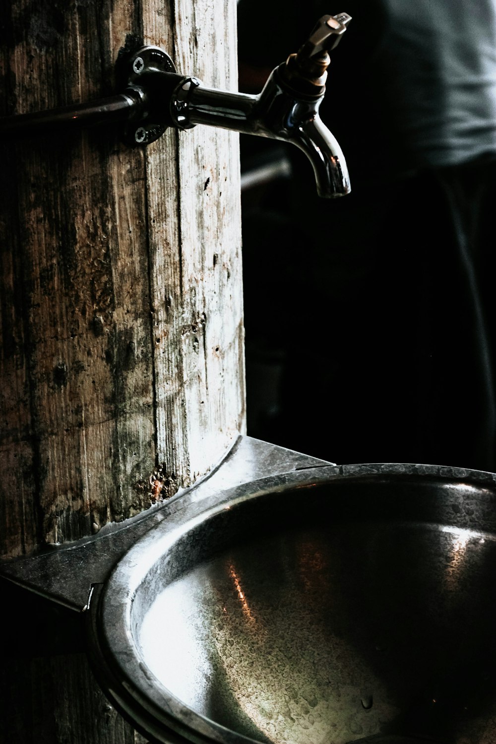 silver spigot over bowl