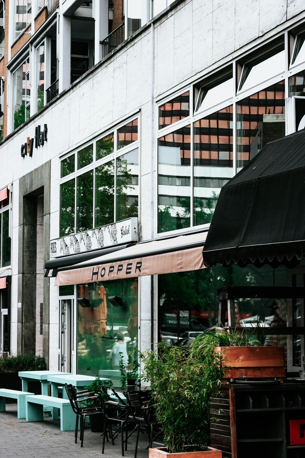 Pflanzen und Tisch vor dem weißen Gebäude