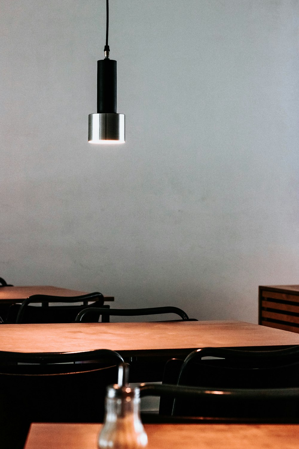 silver pendant lamp over wooden table