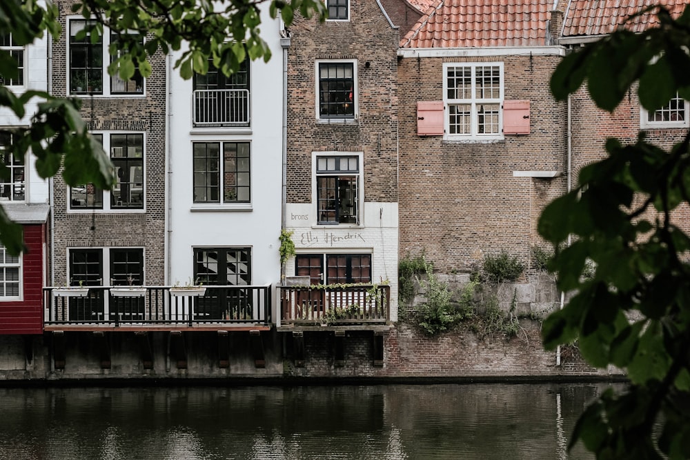 brown concrete building near body of water