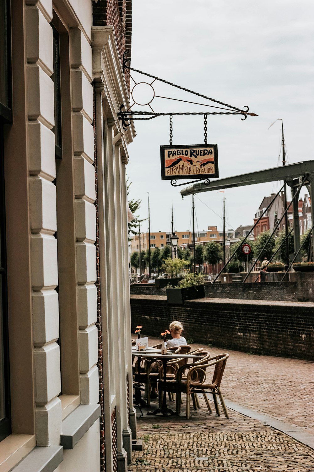 woman sitting beside building