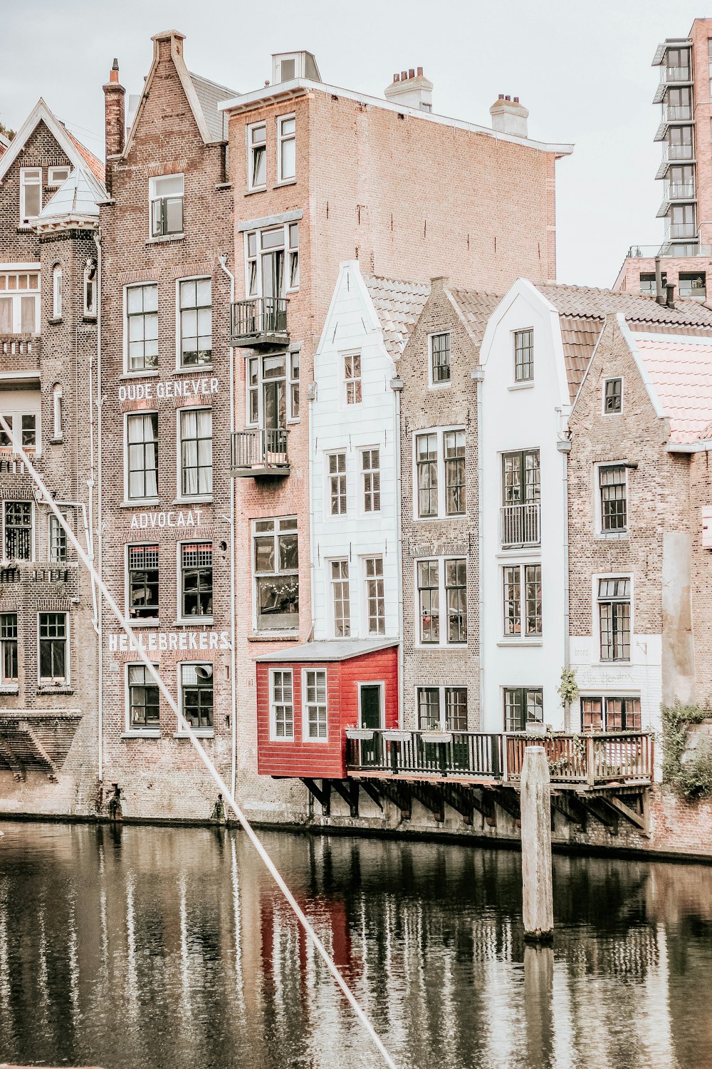 brown concrete buildings near body of water