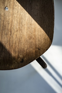 A close-up of a handcrafted wooden chair with metal accents.