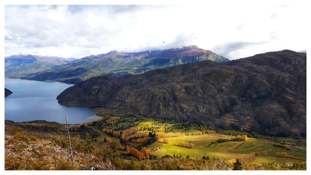 a scenic view of a lake surrounded by mountains