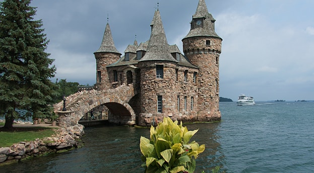 grey and brown stone castle by the sea