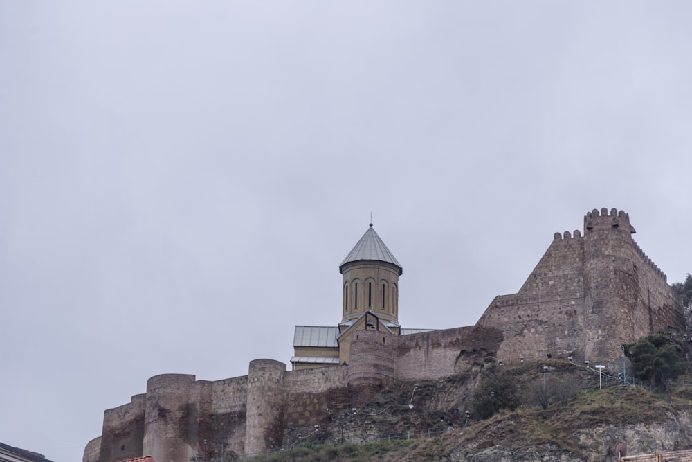 brown castle on top of hill