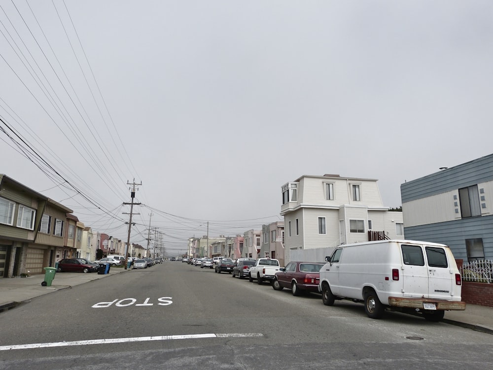 parked vehicles beside curb during daytime