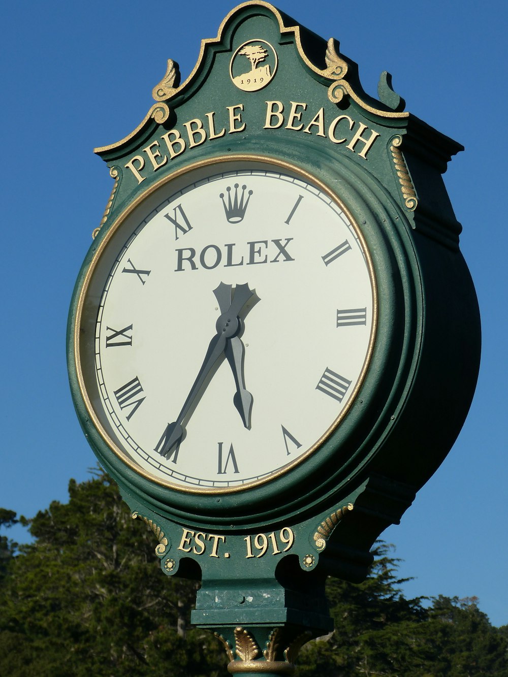 round white and green Rolex Pebble Beach analog clock