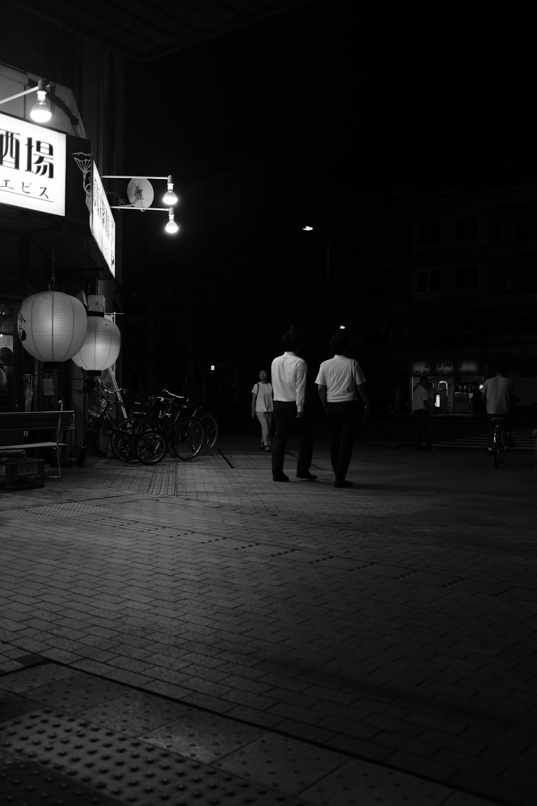 two men walking on pavement