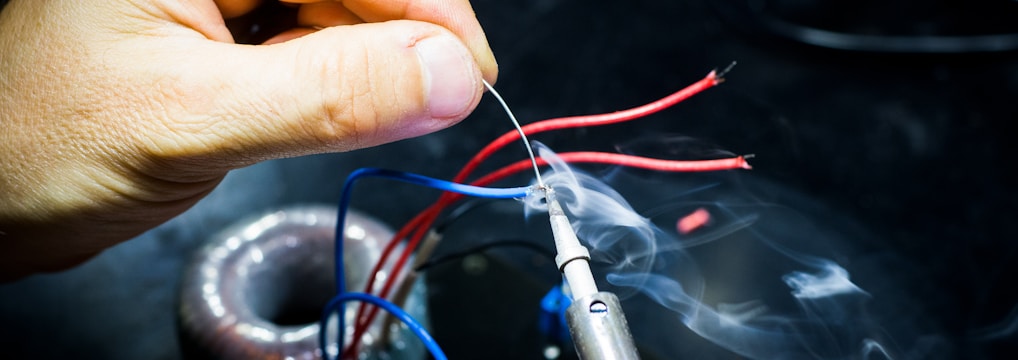 man soldering wires