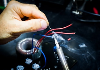 man soldering wires