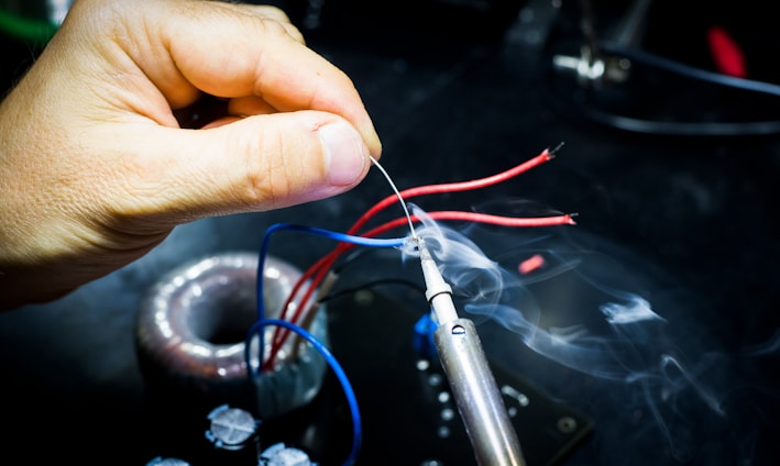 man soldering wires