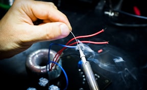 man soldering wires