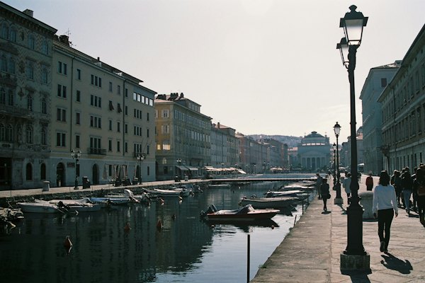 People standing beside body of water and buildings during daytime — Trieste, Italy