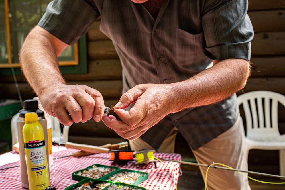 man holding tool standing beside table during daytime