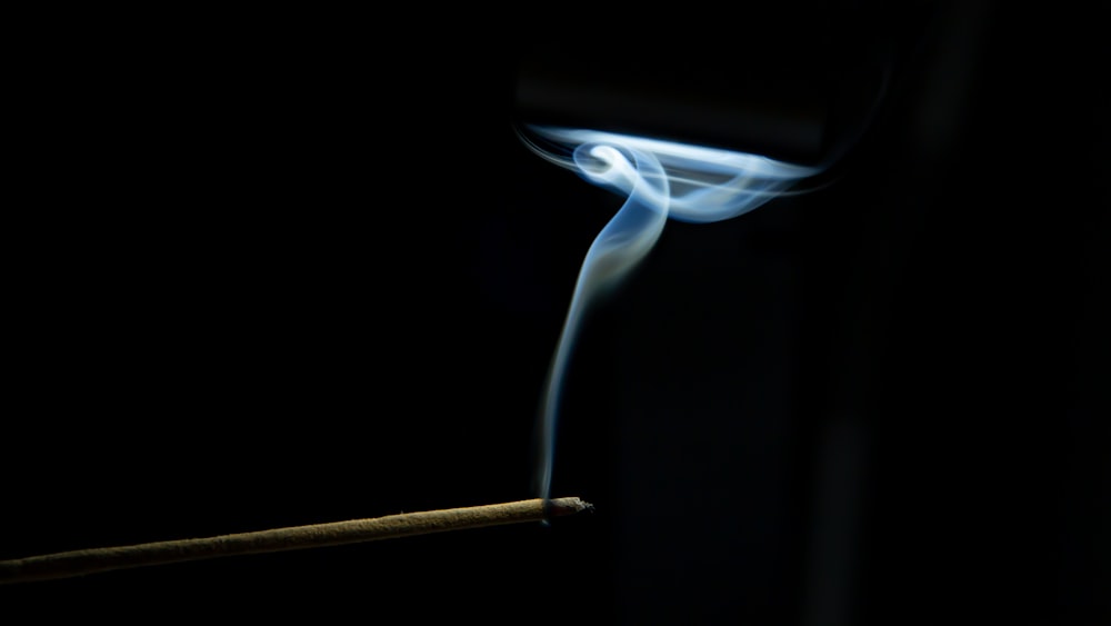 a lit matchstick with smoke coming out of it