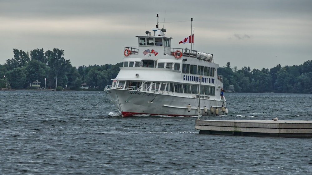 white boat on body of water at daytime