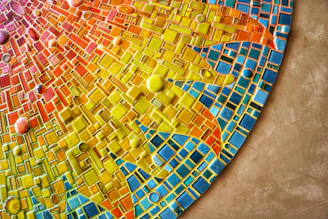 Close-up of a vibrant mosaic artwork featuring traditional Mani patterns in warm Mediterranean tones.