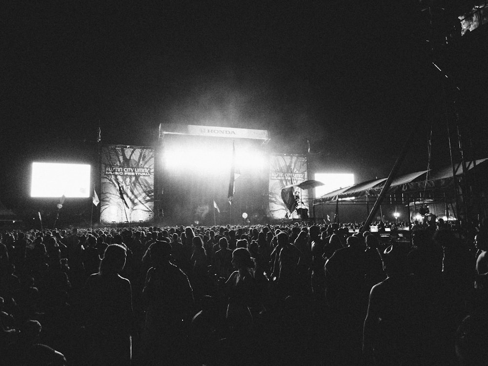 photography of people gathering near outdoor in front of stage during nighttime