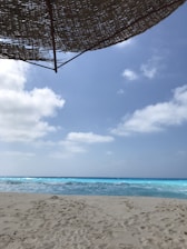 A sunny Punta Cana beach with turquoise waves and white sand.