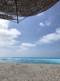 A sunny Punta Cana beach with turquoise waves and white sand.
