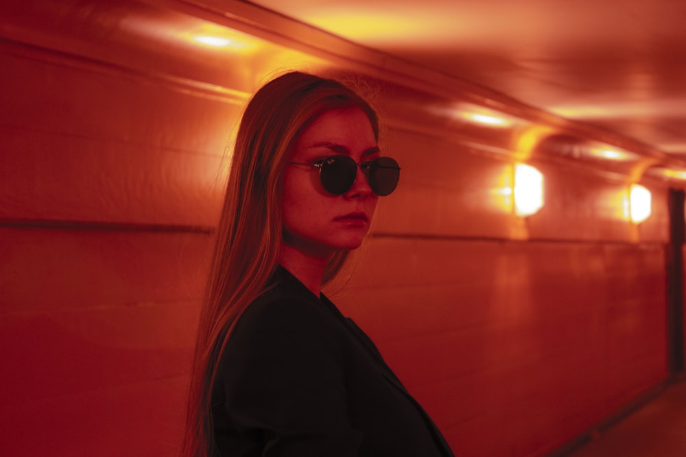 woman on hallway with red lights