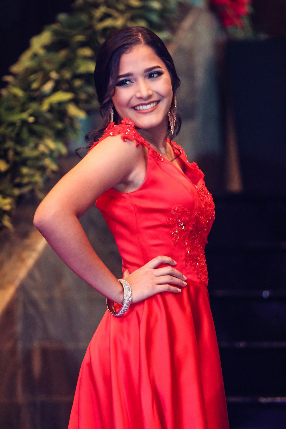 smiling woman wearing red floral sleeveless dress