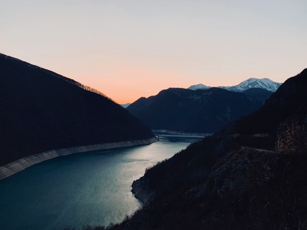 body of water near mountain