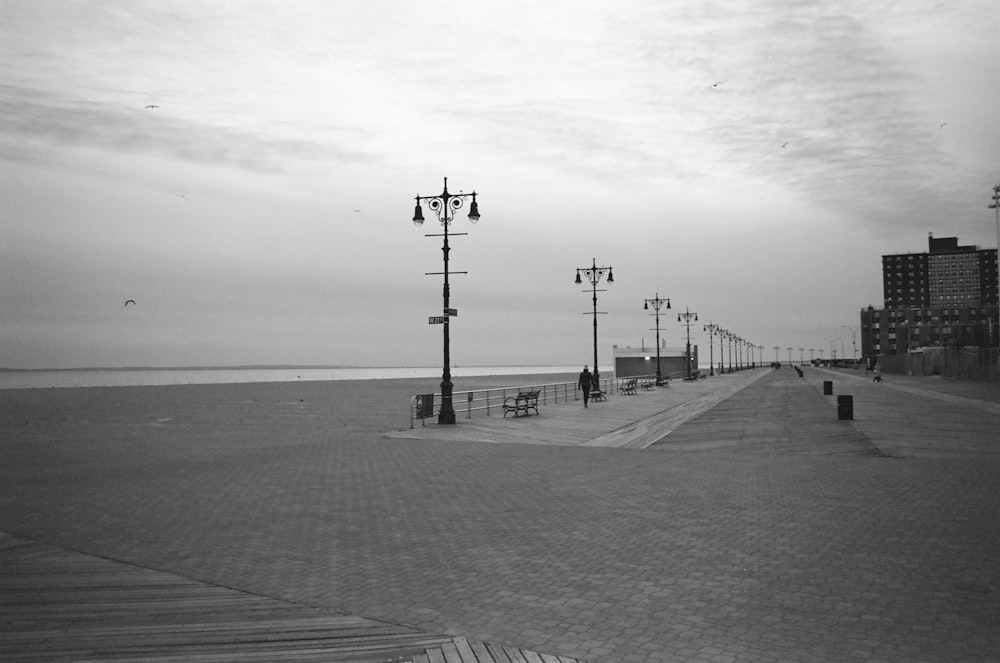 uma foto em preto e branco de um calçadão ao lado do oceano