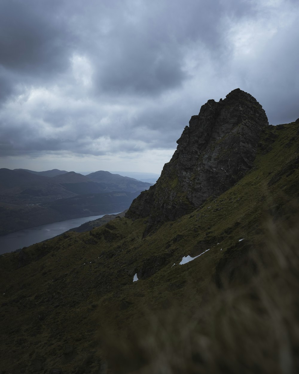 brown mountain across dark clouds