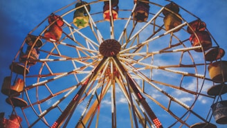 A colorful Ferris wheel illuminated against a twilight sky.