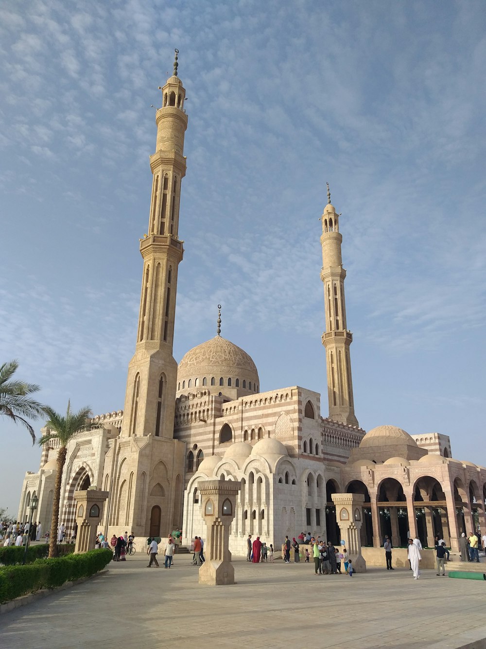 white concrete mosque under cloudy sky