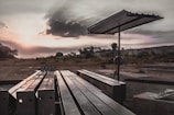 Industrial steel beams arranged in an outdoor storage area under a bright sky.