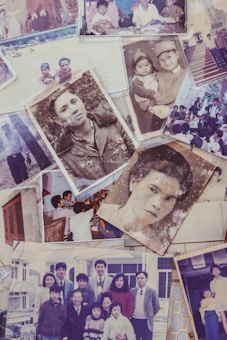 A collection of old family photographs featuring various people in different settings. Some images are sepia or black-and-white, hinting at their age. The photographs show family gatherings, individual portraits, and groups posed together, capturing candid and formal moments.