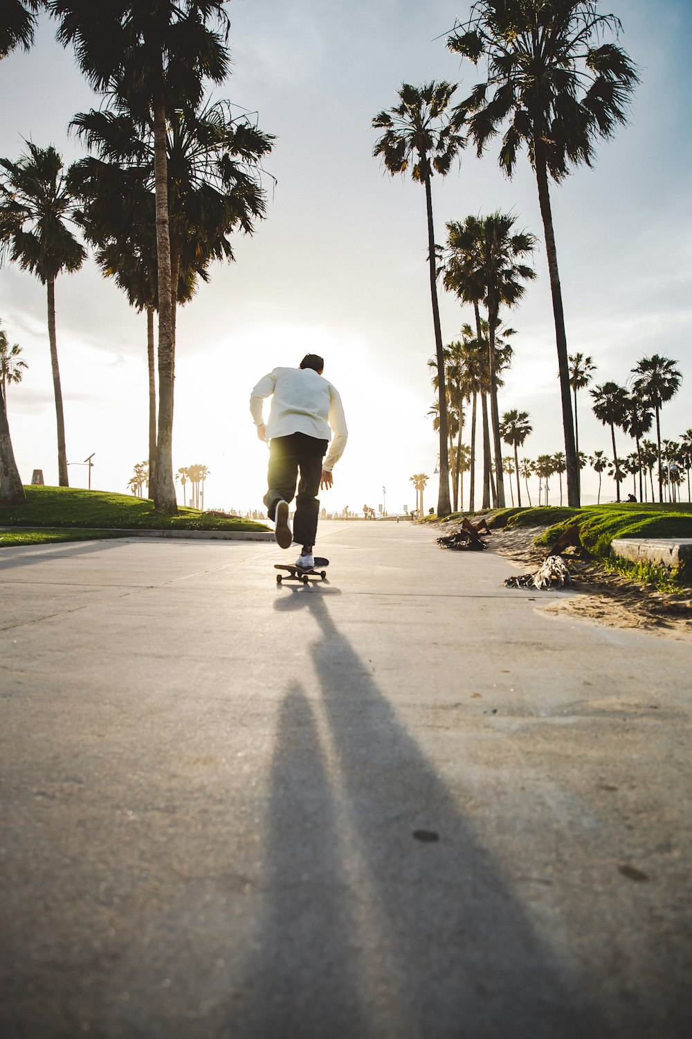 man riding on skateboard on road