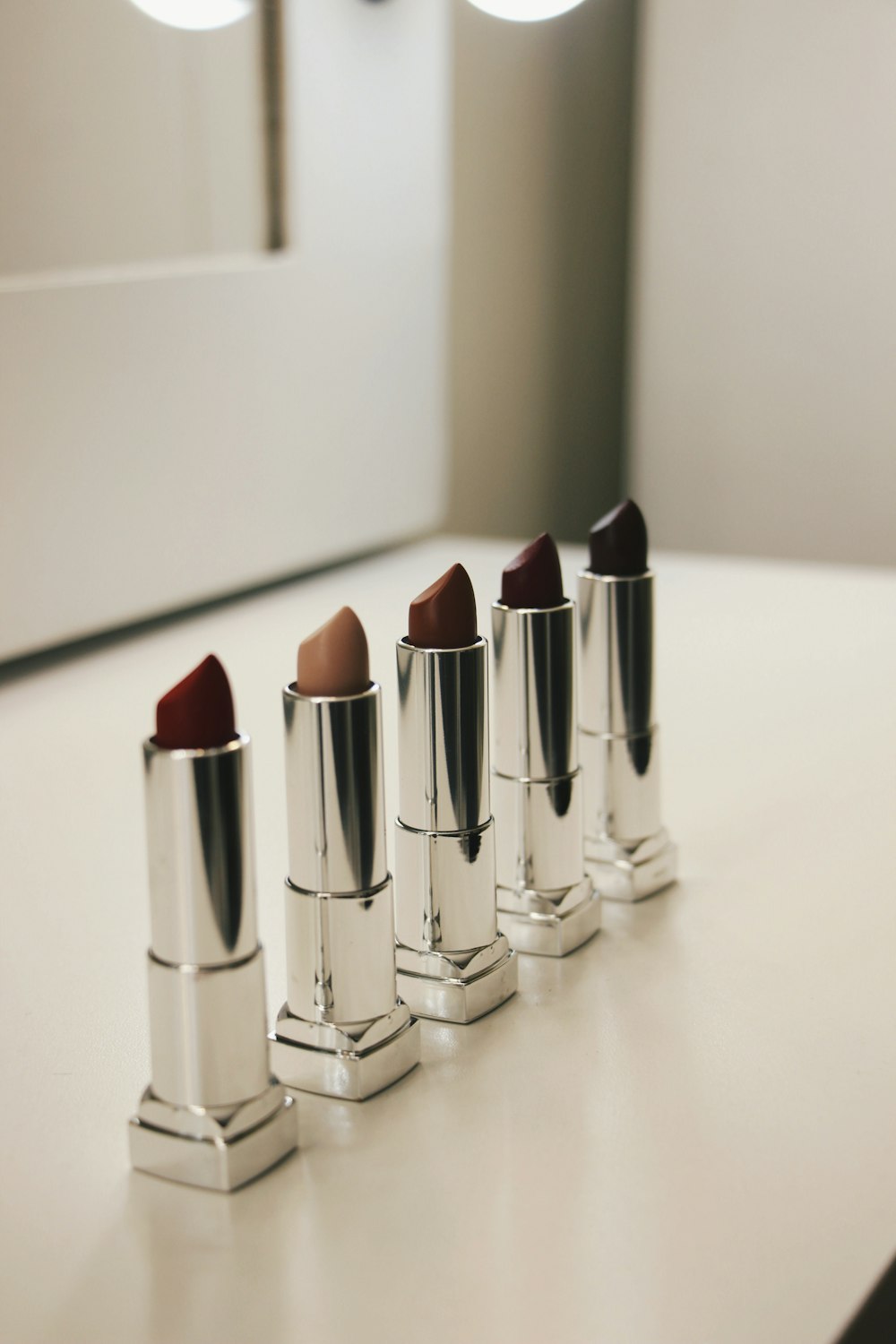 five assorted-color lipsticks