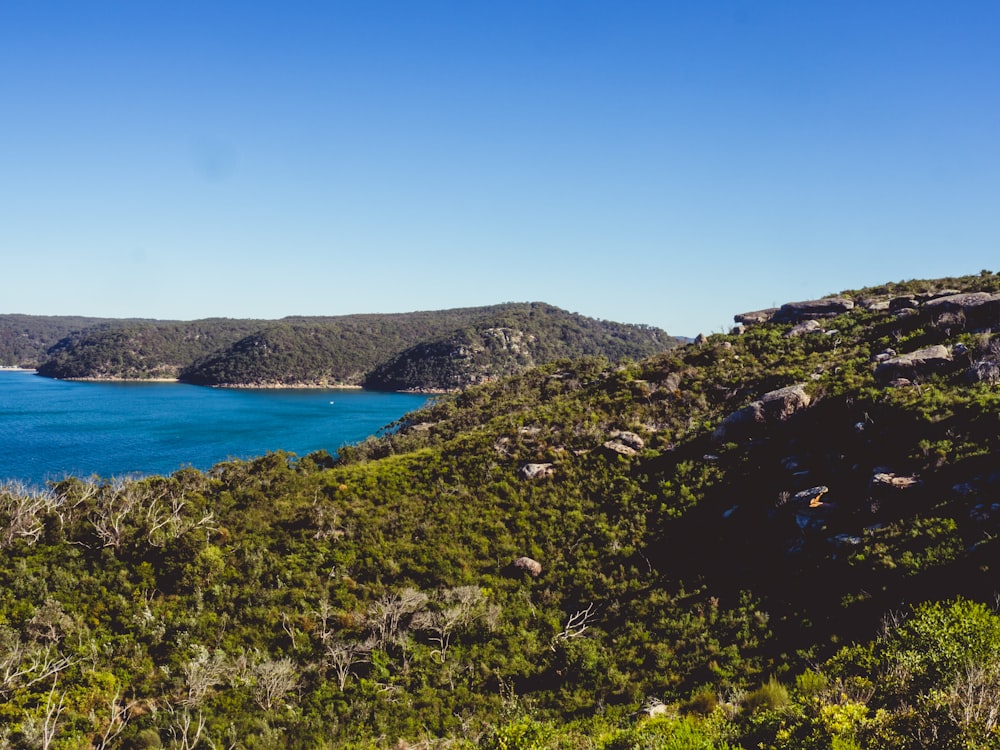 mountain near body of water at daytime