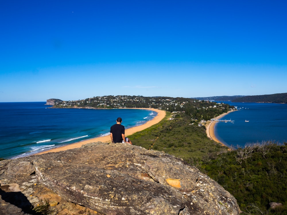 man sitting on hill