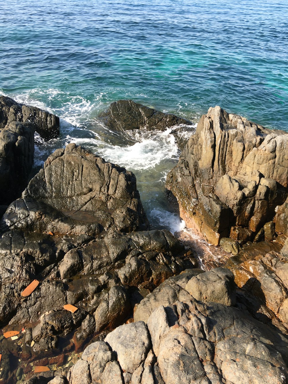 rock formation near body of water during daytime