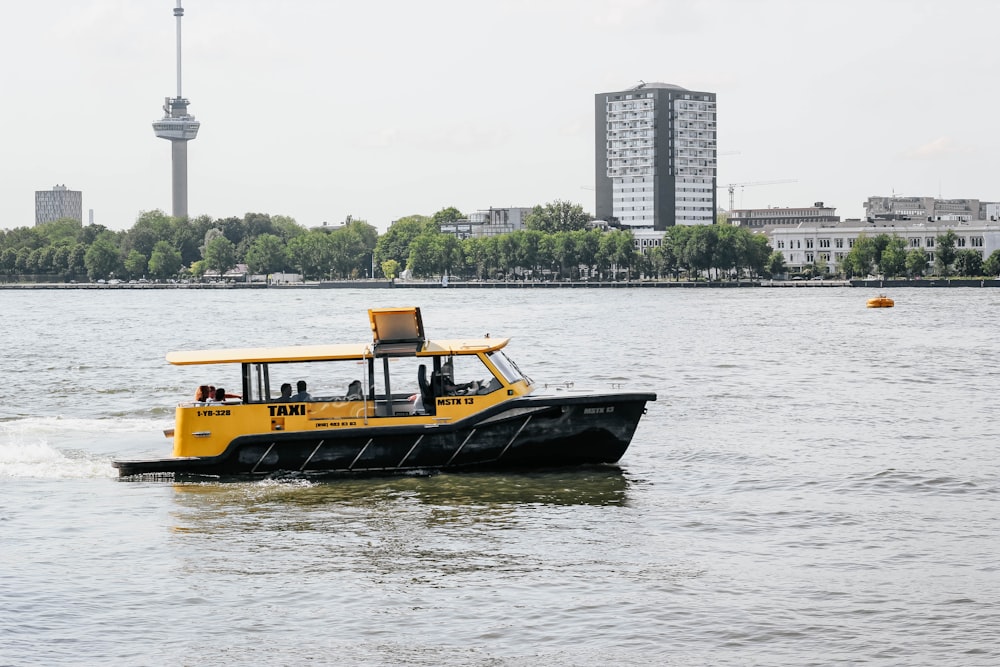 yellow, black, and white boat on body of water