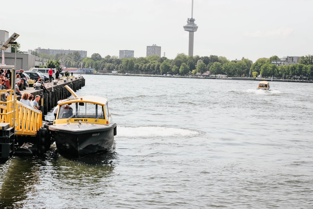 white, black, and yellow boat on body of water