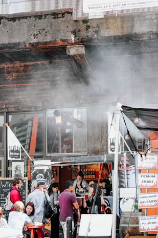 A busy food cart with a variety of traditional Brazilian street foods ready to serve.