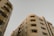 High-rise residential buildings with modern architectural design. The structures feature multiple floors with balconies and windows. The facade is composed of neutral-colored materials, giving it a sleek and sophisticated look.