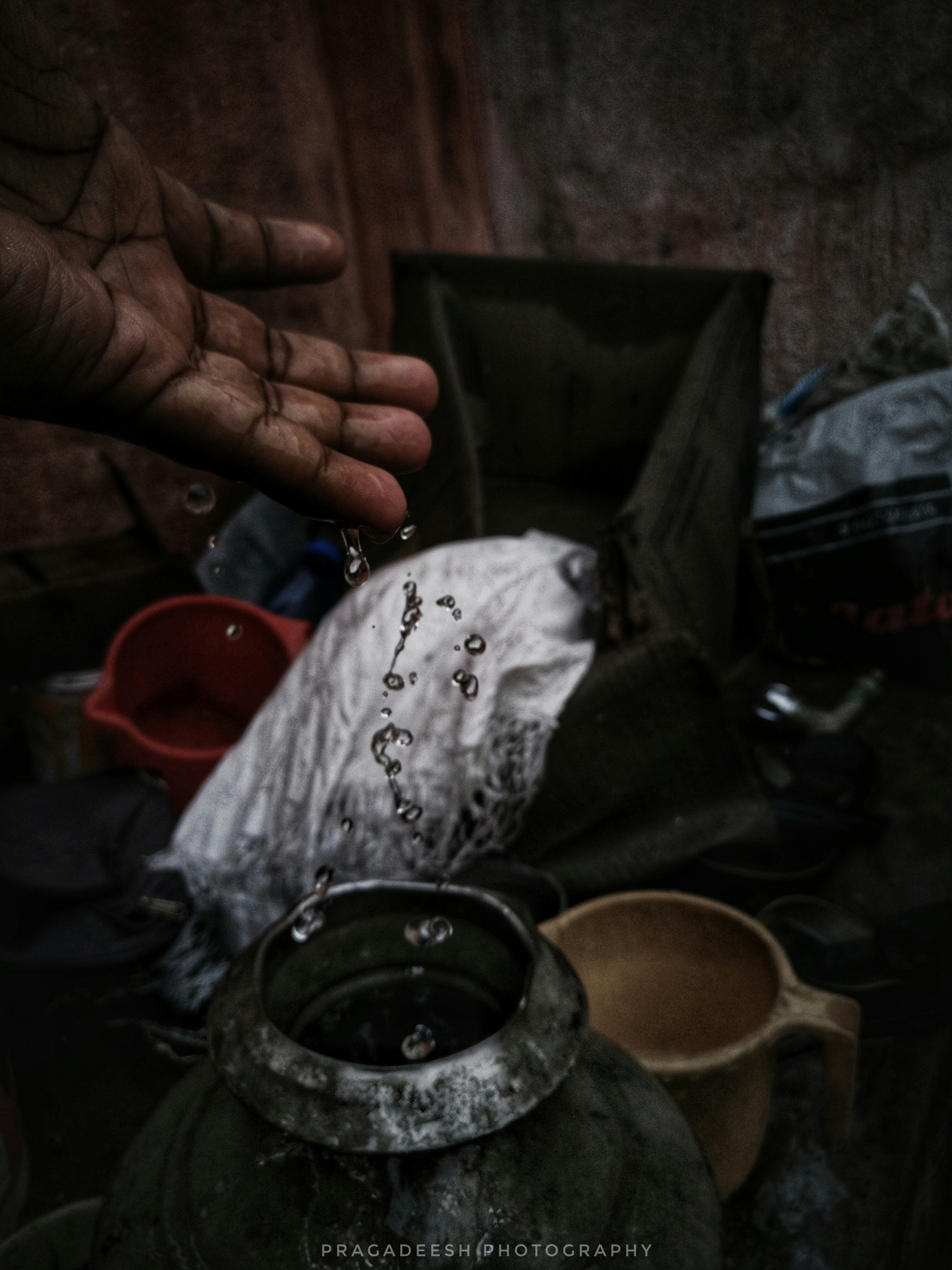 a person holding out their hand over a pile of items