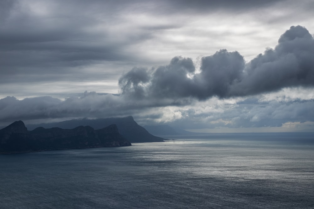 a large body of water under a cloudy sky