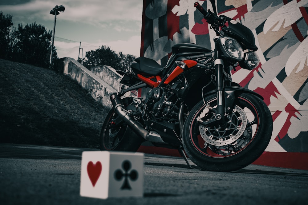 shallow focus photo of black and red naked bike