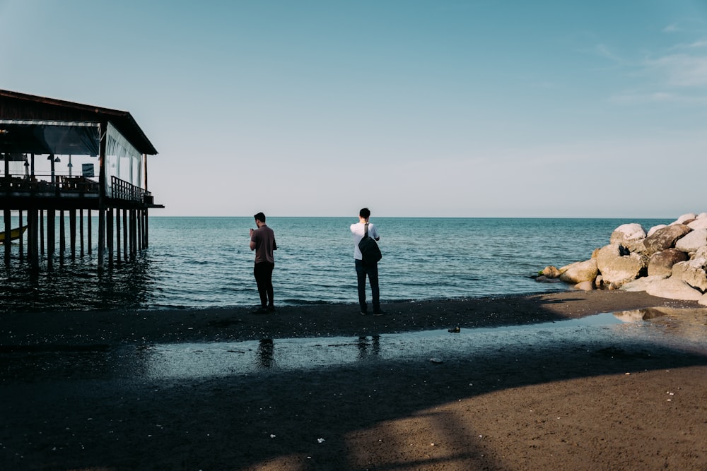 person standing on seashore during daytime